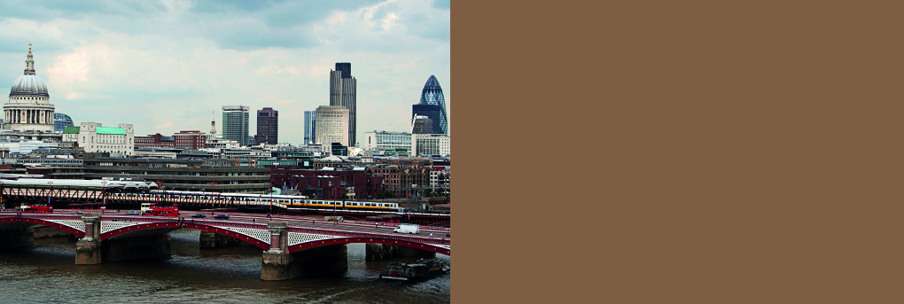 Train passing over Blackfriars Bridge in Central London. St Pauls and Gerkin in background.