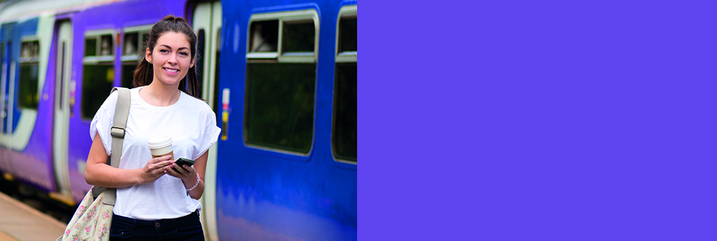 Young women leaving train and walking on platform.